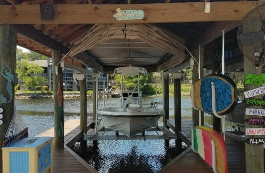 Beautiful Touchless Boat Cover open on a covered dock.
