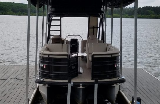 Pontoon boat on a floating dock with the touchless boat cover