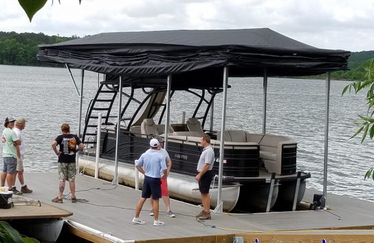 Pontoon boat on a floating dock with the touchless boat cover. Automatic boat cover
