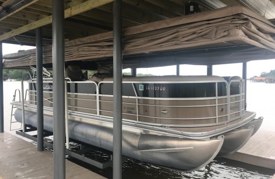 Automatic boat cover on a floating dock, lakeside. no more snaps or straps on this automatic pontoon boat cover.