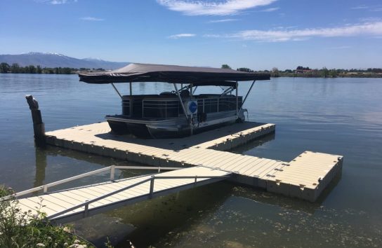 Canopy boat cover on a floating dock, lakeside. no more snaps or straps on this automatic boat cover.