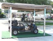 Beige Colored Automatic Golf Cart Cover outside of a house