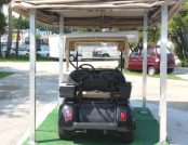 Beige Colored Automatic Golf Cart Cover outside of a house