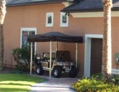 Grey Colored Automatic Cover for a Golf Cart outside of a house